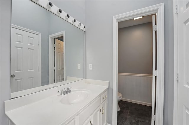 2016 NE Summerfield Ct, Blue Springs, MO 64029 - bathroom with vanity, tile patterned flooring, and a wainscoted wall