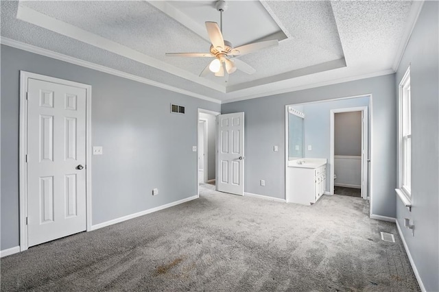 2016 NE Summerfield Ct, Blue Springs, MO 64029 - unfurnished bedroom with a textured ceiling, a tray ceiling, carpet flooring, crown molding, and a ceiling fan
