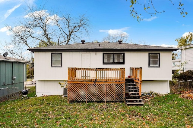 rear view of house featuring a yard, central air condition unit, and a deck