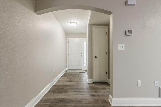 corridor with dark wood-type flooring