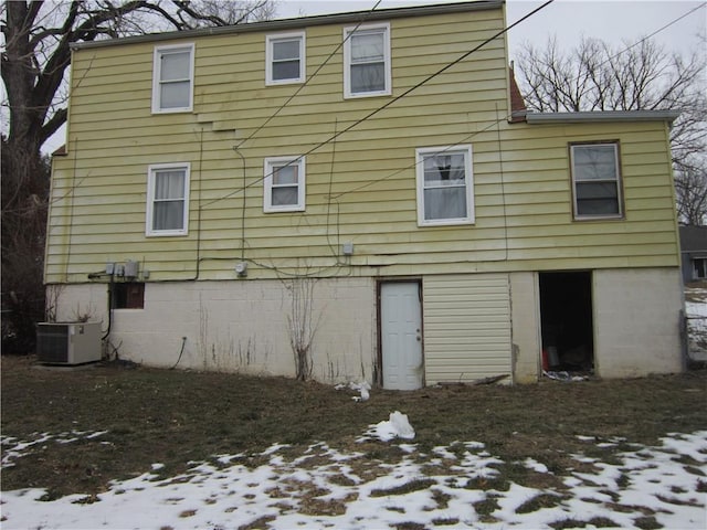 snow covered house with cooling unit