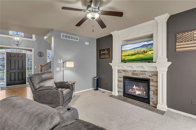 living area featuring baseboards, visible vents, and carpet flooring