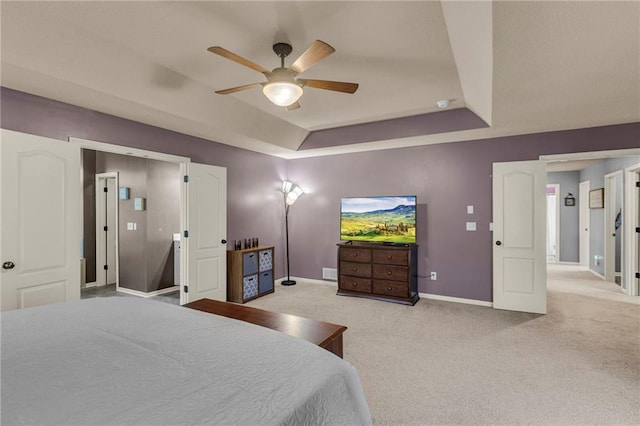 bedroom featuring visible vents, a ceiling fan, baseboards, carpet, and a raised ceiling