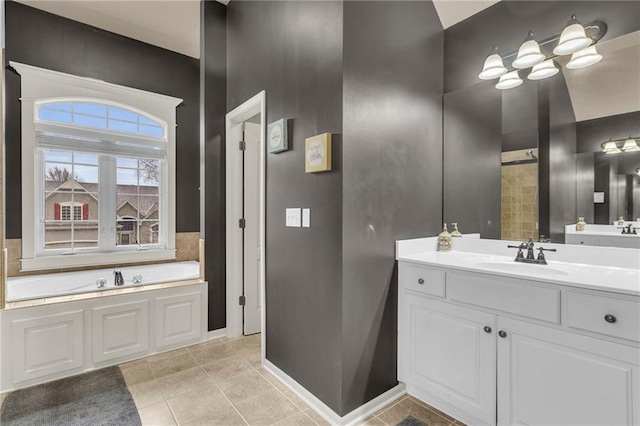 bathroom with tile patterned floors, vanity, and a bath