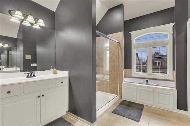 full bath featuring a garden tub, a shower stall, tile patterned flooring, and vanity