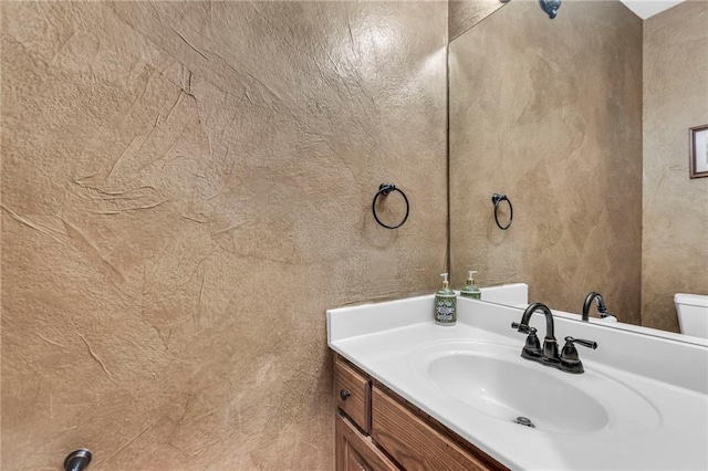 bathroom with toilet and vanity