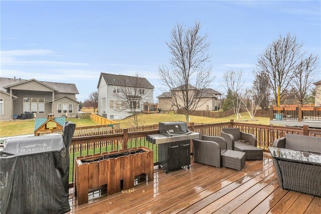 wooden terrace featuring fence, outdoor lounge area, and a yard