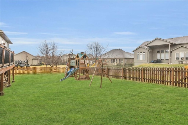 view of playground featuring a yard and a fenced backyard