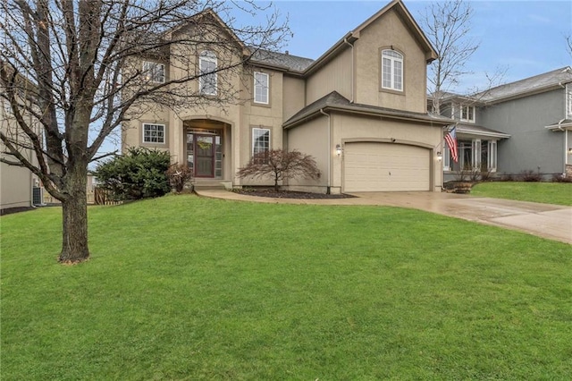 traditional-style house featuring a front yard, driveway, an attached garage, and stucco siding