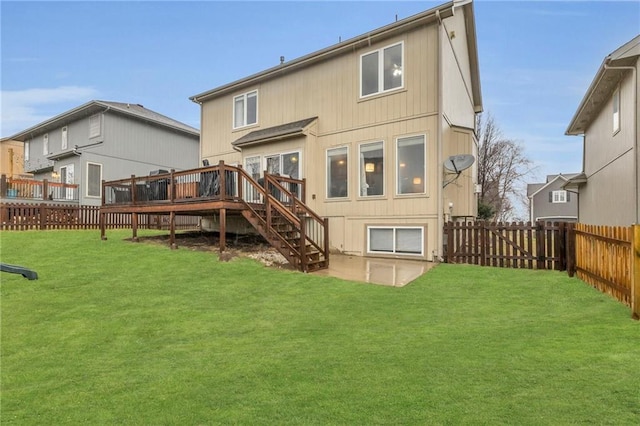 back of property with stairs, a yard, a fenced backyard, and a wooden deck