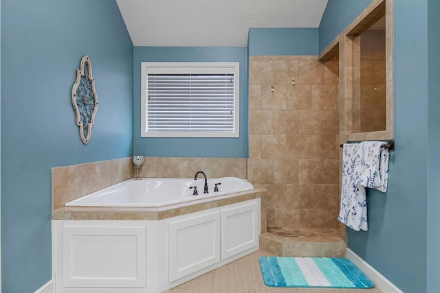 bathroom featuring independent shower and bath