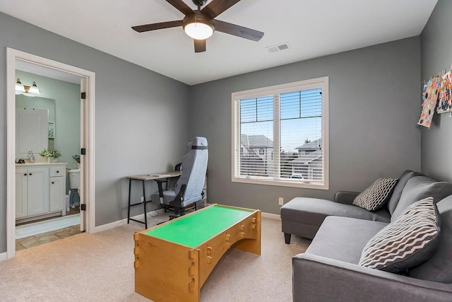 recreation room featuring light carpet and ceiling fan