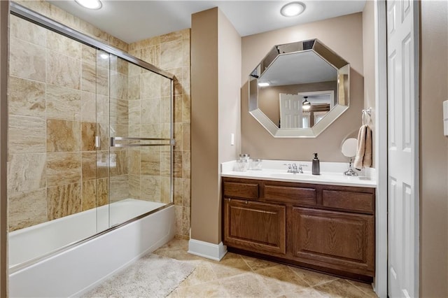 bathroom featuring tile patterned flooring, combined bath / shower with glass door, and vanity