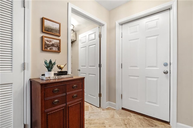 doorway featuring baseboards