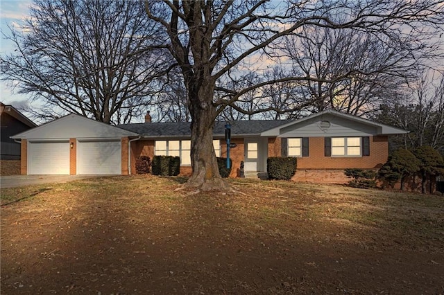 ranch-style house featuring a yard and a garage