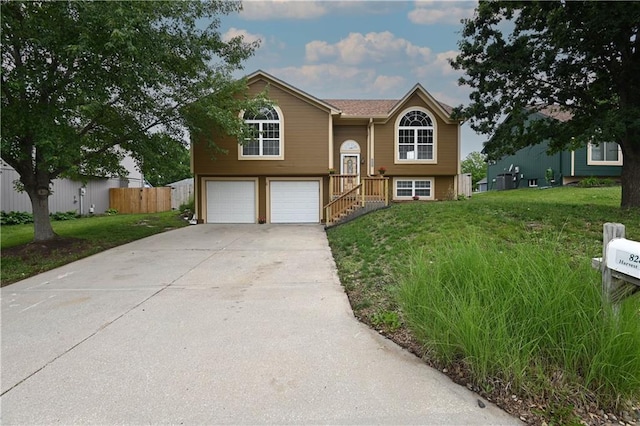828 SW Harvest Dr, Grain Valley, MO 64029 - split foyer home with concrete driveway and an attached garage