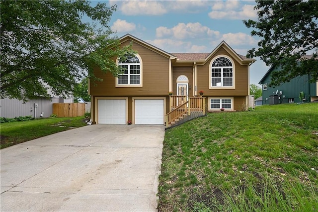 828 SW Harvest Dr, Grain Valley, MO 64029 - bi-level home with a garage and concrete driveway