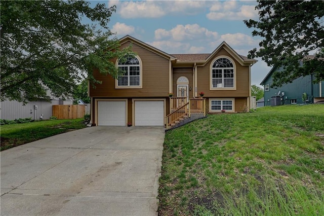 828 SW Harvest Dr, Grain Valley, MO 64029 - raised ranch with an attached garage and concrete driveway