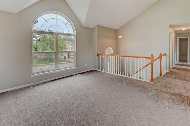 828 SW Harvest Dr, Grain Valley, MO 64029 - spare room with vaulted ceiling, carpet floors, and baseboards