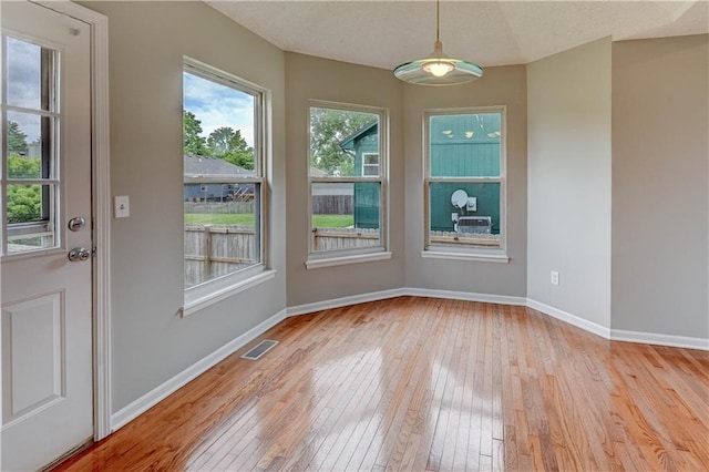 828 SW Harvest Dr, Grain Valley, MO 64029 - unfurnished dining area with hardwood / wood-style floors and baseboards