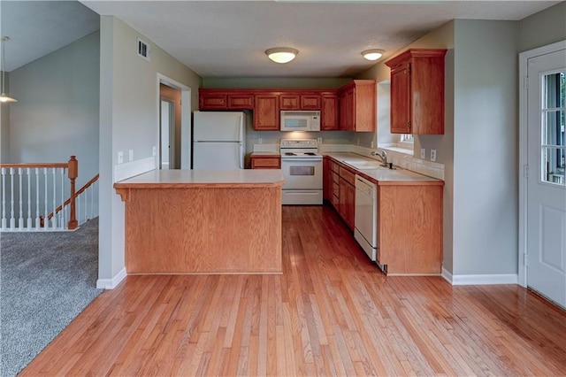 828 SW Harvest Dr, Grain Valley, MO 64029 - kitchen with white appliances, light wood-style floors, a peninsula, light countertops, and baseboards