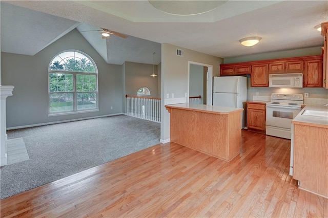 828 SW Harvest Dr, Grain Valley, MO 64029 - kitchen featuring white appliances, ceiling fan, light countertops, open floor plan, and lofted ceiling