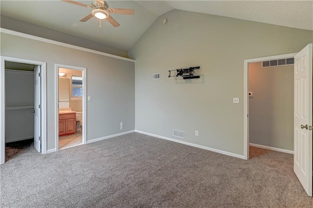 828 SW Harvest Dr, Grain Valley, MO 64029 - unfurnished bedroom with a walk in closet, vaulted ceiling, light colored carpet, baseboards, and a closet