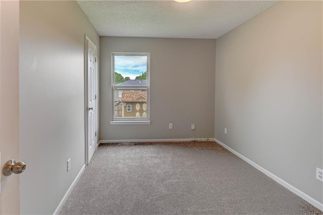 828 SW Harvest Dr, Grain Valley, MO 64029 - spare room with carpet flooring, a textured ceiling, and baseboards