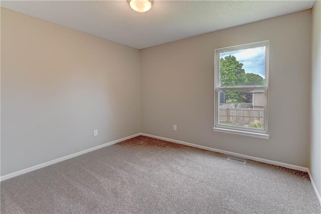 828 SW Harvest Dr, Grain Valley, MO 64029 - carpeted empty room with baseboards and a textured ceiling