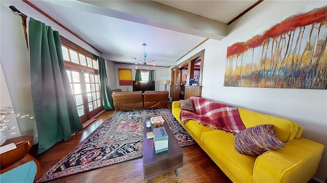 living room featuring an inviting chandelier, dark hardwood / wood-style floors, and beamed ceiling