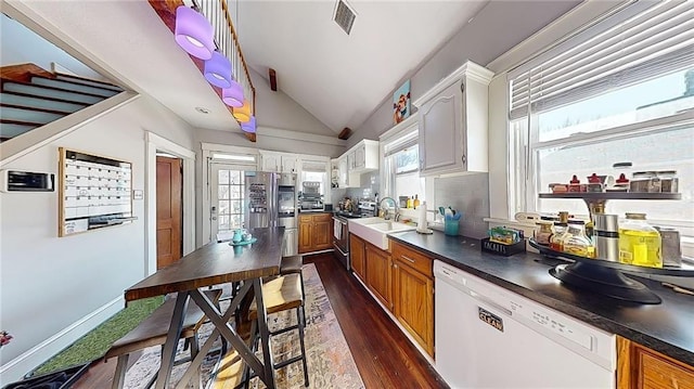 kitchen with stainless steel appliances, a wealth of natural light, decorative backsplash, and white cabinets