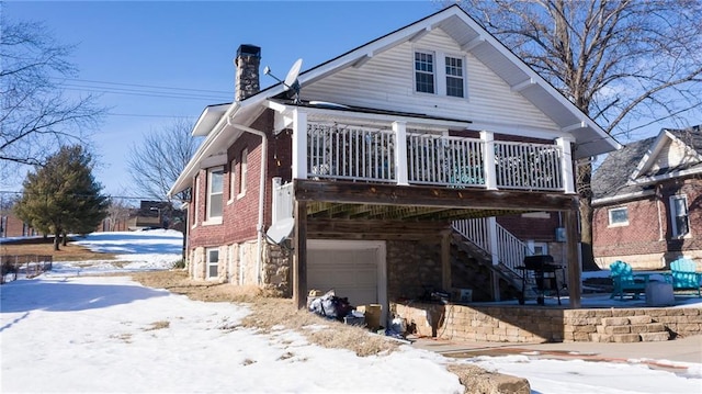 snow covered house with a garage