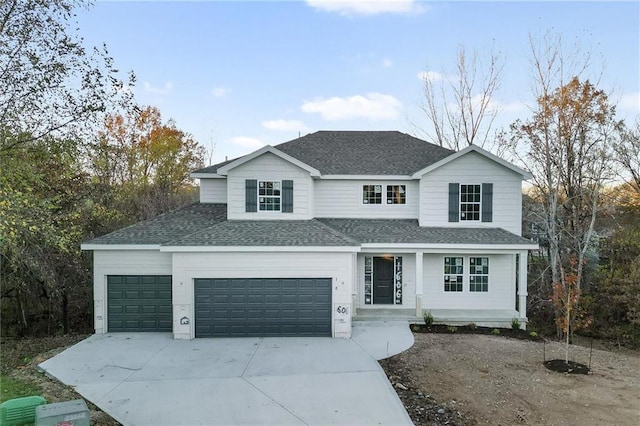 traditional home featuring a garage, concrete driveway, roof with shingles, and a porch