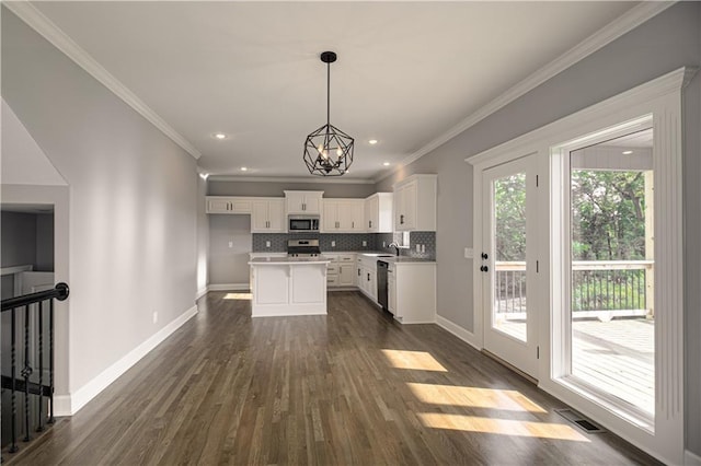 kitchen featuring visible vents, white cabinets, appliances with stainless steel finishes, dark wood-style floors, and tasteful backsplash