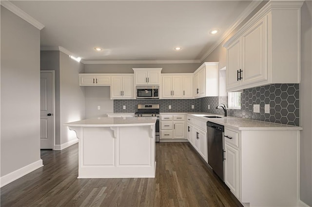 kitchen featuring stainless steel appliances, white cabinets, crown molding, and dark wood-style floors