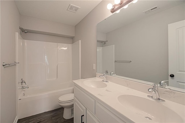 11821 N Bellaire Ave, Kansas City, MO 64156 - full bathroom featuring toilet, shower / bath combination, wood finished floors, and double vanity