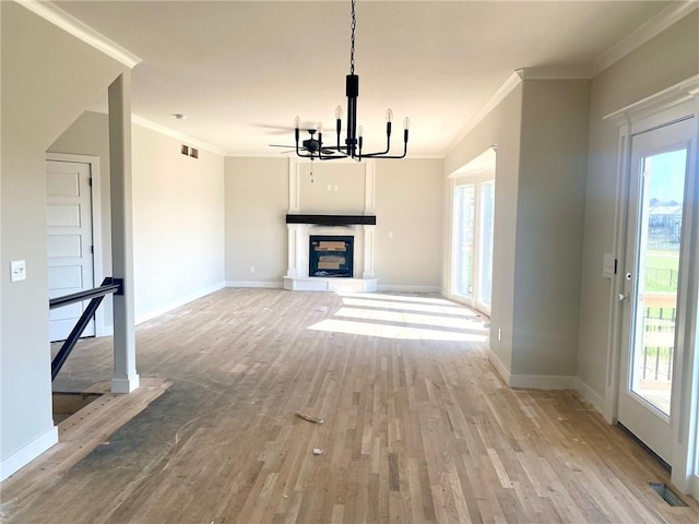 11821 N Bellaire Ave, Kansas City, MO 64156 - unfurnished living room featuring ornamental molding, light wood finished floors, plenty of natural light, and a chandelier