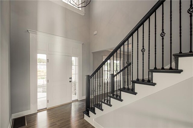 11821 N Bellaire Ave, Kansas City, MO 64156 - foyer entrance with a high ceiling, stairs, baseboards, and wood finished floors