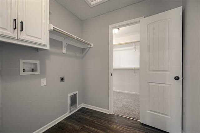 11821 N Bellaire Ave, Kansas City, MO 64156 - washroom with electric dryer hookup, cabinet space, hookup for a washing machine, baseboards, and dark wood finished floors