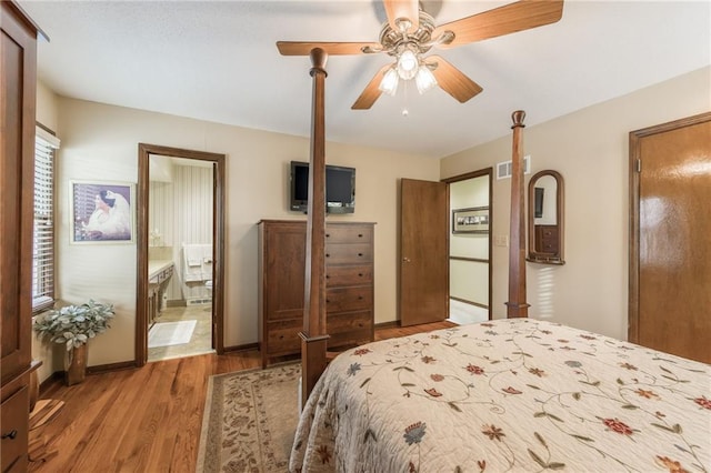 bedroom featuring ceiling fan, light hardwood / wood-style floors, and ensuite bath