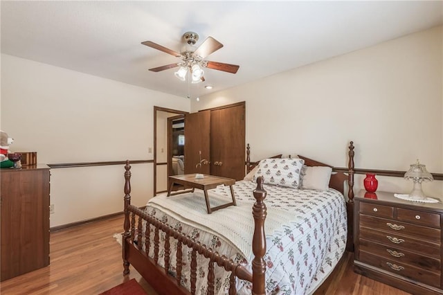 bedroom with ceiling fan, light wood-type flooring, and a closet