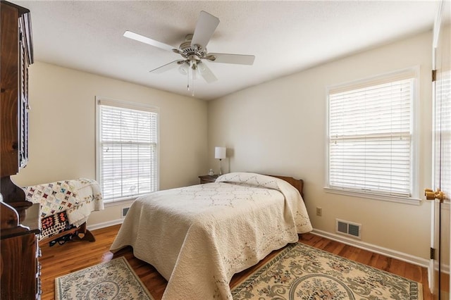 bedroom with hardwood / wood-style flooring and ceiling fan