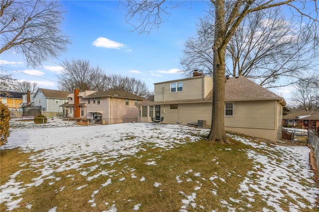 view of snow covered rear of property