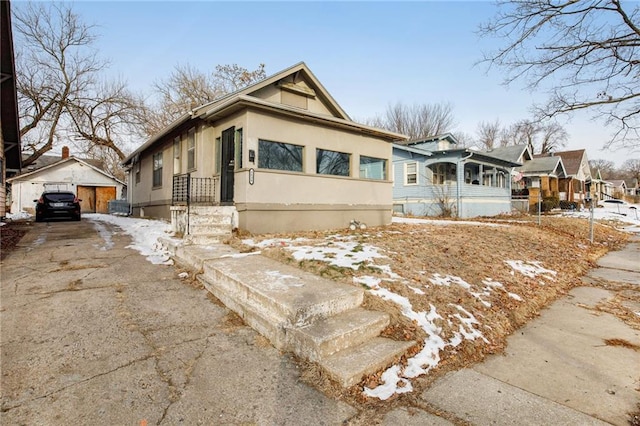 bungalow-style home featuring an outbuilding and a garage