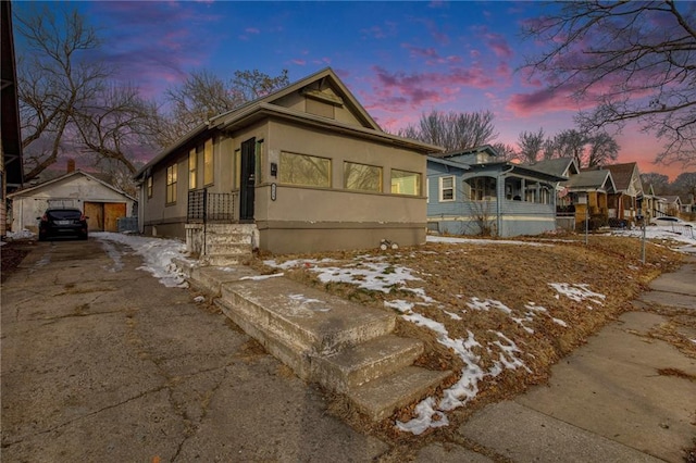 view of front of property with a garage and an outbuilding