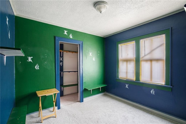 unfurnished bedroom featuring carpet flooring and a textured ceiling