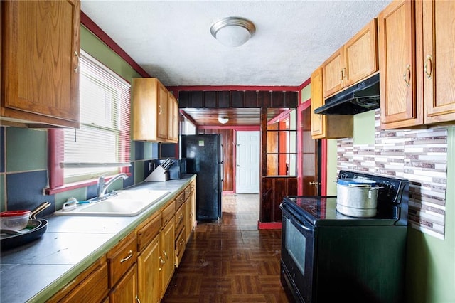 kitchen with black refrigerator, dark parquet floors, sink, backsplash, and stove