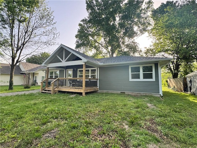 715 N Mulberry St, Adrian, MO 64720 - rear view of property featuring a lawn, a deck, and roof with shingles