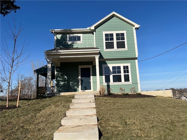 view of front of home with covered porch and a front lawn