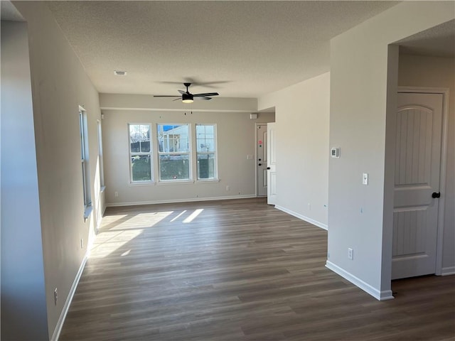 empty room with ceiling fan, a textured ceiling, and dark hardwood / wood-style flooring